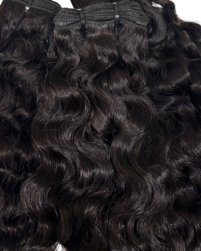 Close-up of Burmese curly hair extensions with a white background