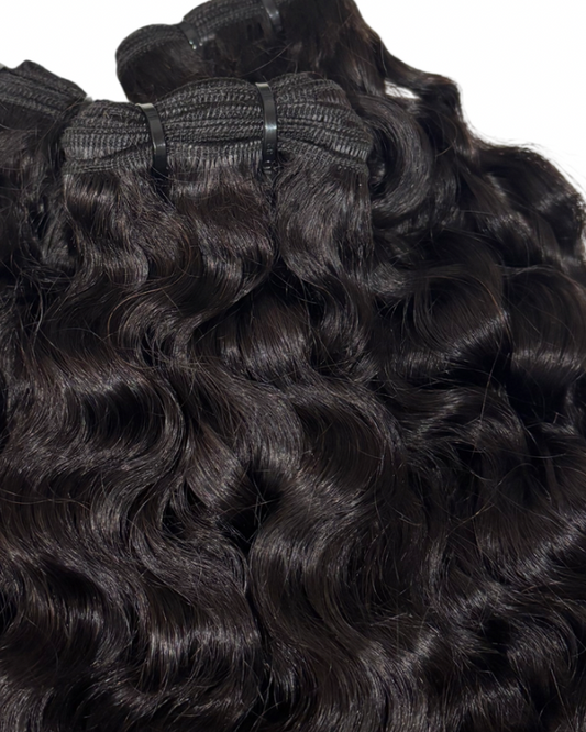 Natural 1B Burmese Curly bundles with a close-up view on a white background