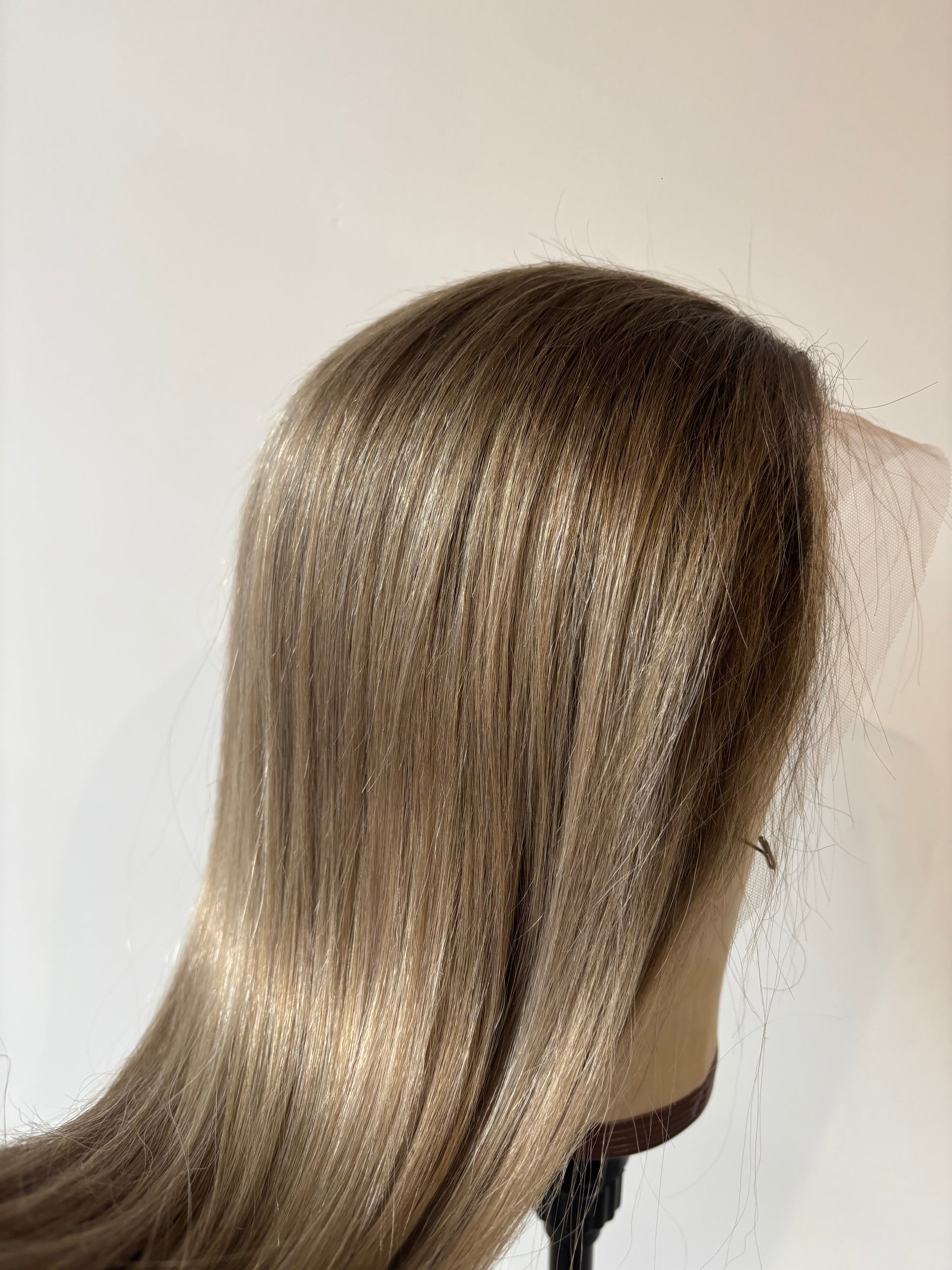Blonde hair extensions on a white background