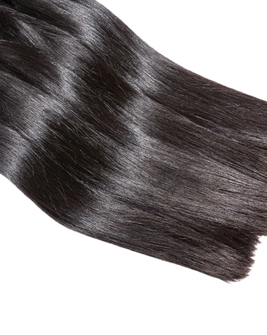 Bundle of black hair extensions on a white background
